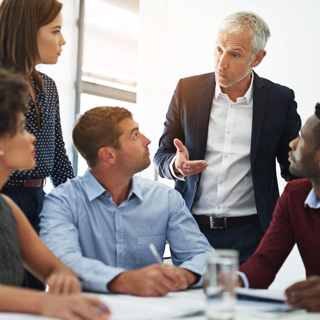 shot of corporate businesspeople in the boardroom